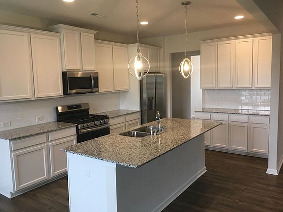 Kitchen with Gas Range, Microwave, Fridge, and SS Dishwasher. The kitchen offers a walk-in pantry and nook for buffet table.