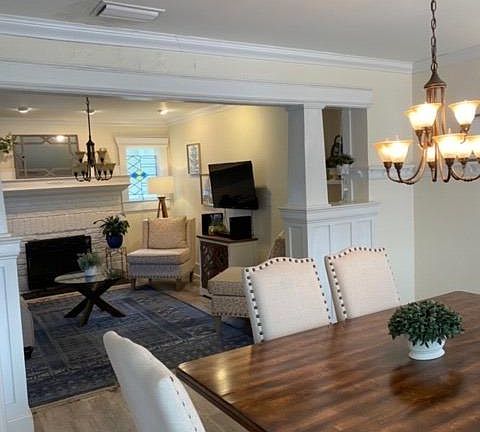 Dining room and living room with original lights and architecture cornice
