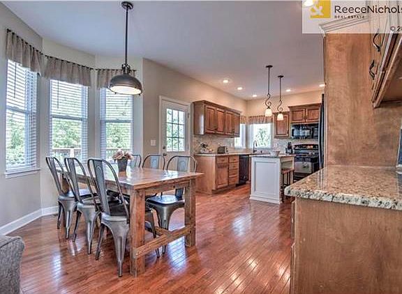 This view of the spacious kitchen highlights the bay window and  great, updated light fixtures.  The home offers knock down ceilings throughout.