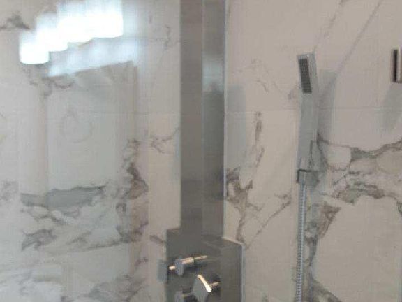 Waterfall showerhead with body jets in the master bathroom