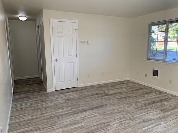 Living room look to the hallway and coat closet.