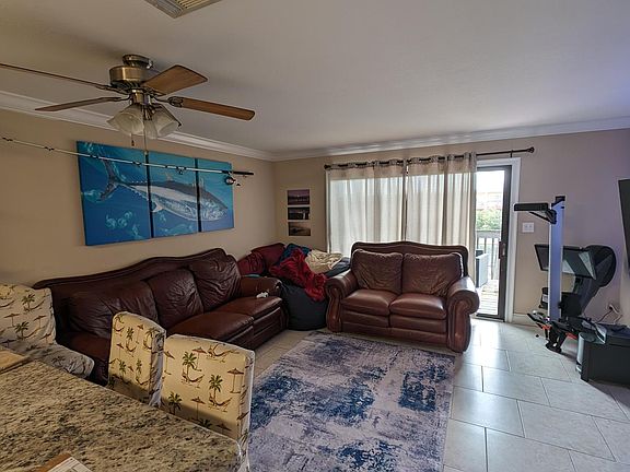 living room with back deck overlooking pond
