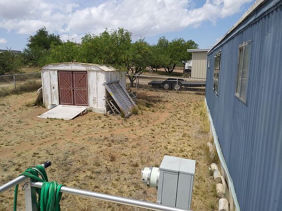 Fenced in back yard with 10x10 storage shed now repainted
