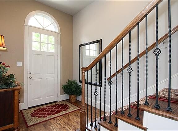 Fabulous entry with hardwoods and iron stair railings