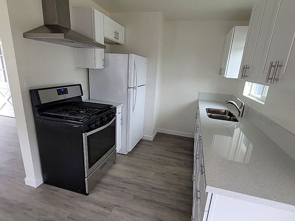 Kitchen quartz counters. Soft close shaker cabinets. 5 burner stove with grill plate.