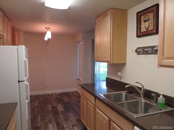 Kitchen with new maple cabinets, newer stainless steel sink, Quartz counter tops and beautiful wood 