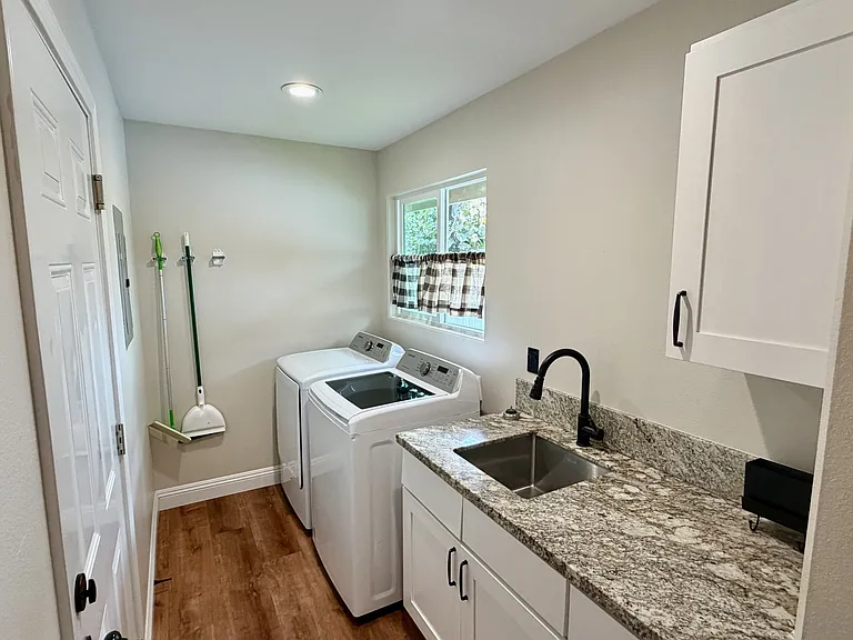 Laundry room with deep sink and storage space