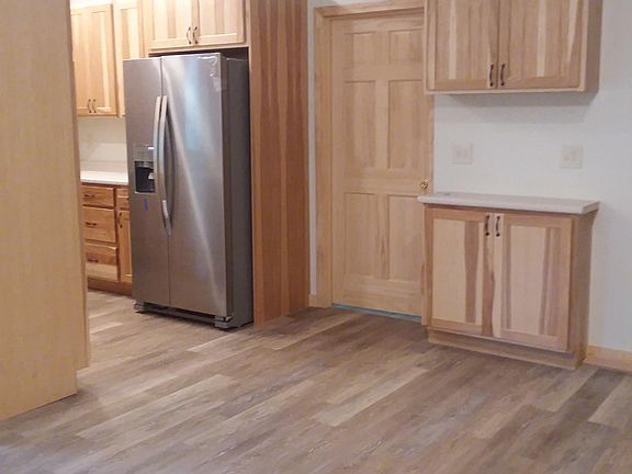 Wood cabinets, wood doors, pantry storage in kitchen.