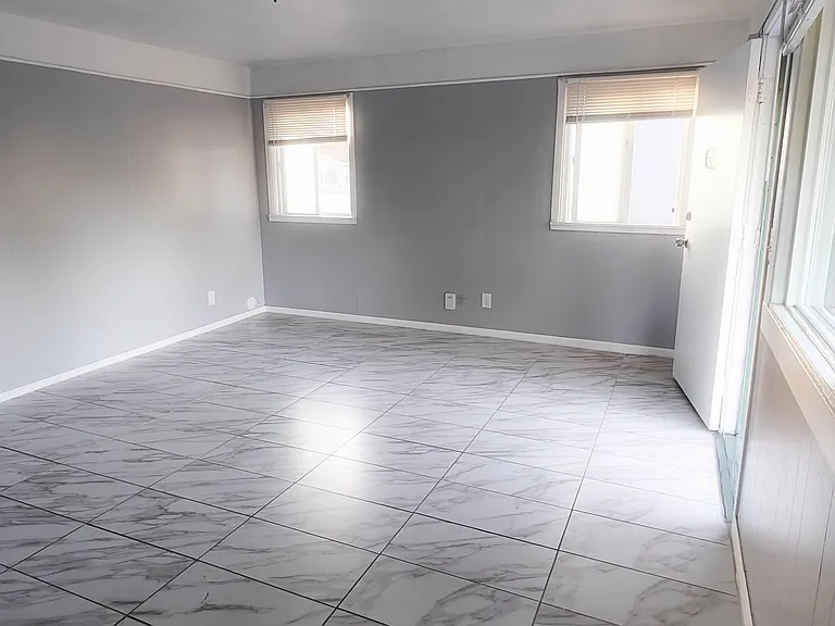 Fully remodeled living room tons of sunlight. View from kitchen.