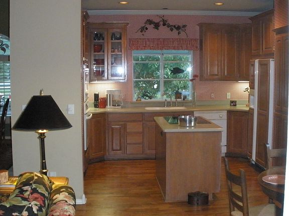 Kitchen has stone countertops and built-in refrigerator
