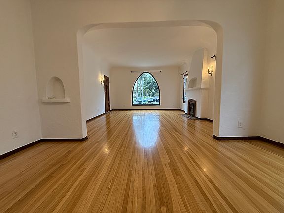 Living Room and Dining Room with Newly refinished original hardwood floors.