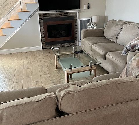Living Room with gas fireplace and flat screen smart TV