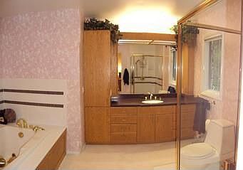 The master bedroom bathroom has a whirlpool tub and a large shower. Updated cabinets and Corian coun