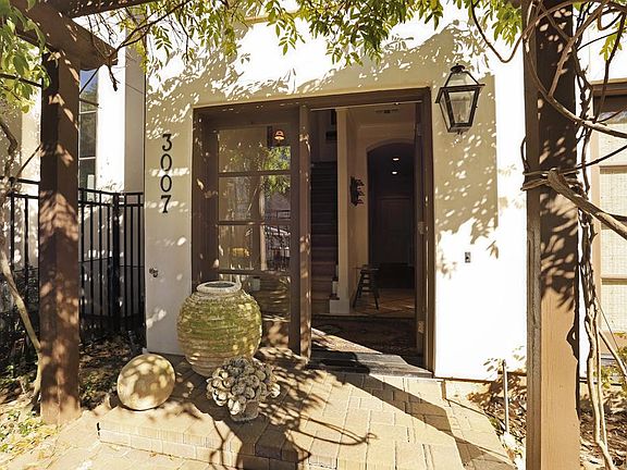 Once through the rod iron front gate, which has an intercom, one enters the front entry of this home