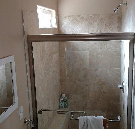 Huge shower constructed of rich travertine