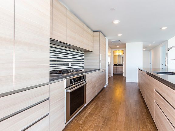 sleek modern cabinetry, Caesarstone counters, Thermador cabi