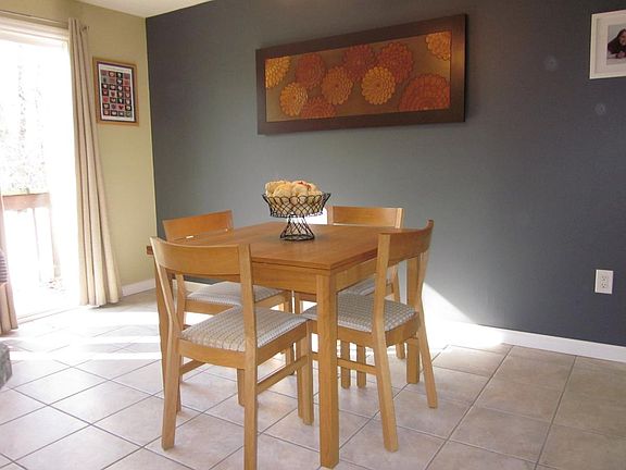 sliders open to wooden deck. back patio os quiet and spaciou