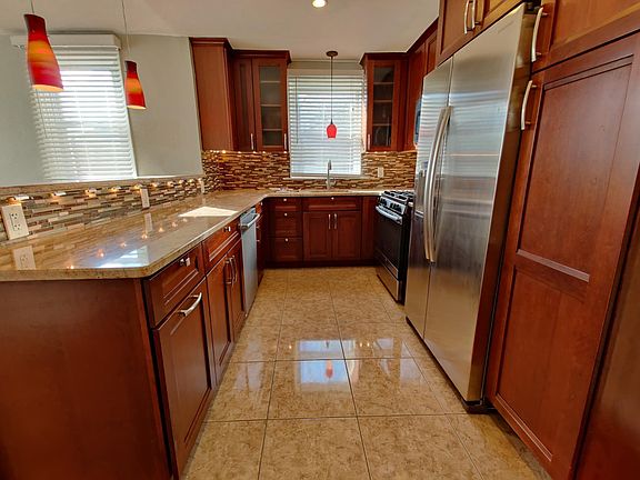 Kitchen includes stainless steel appliances and updated layout