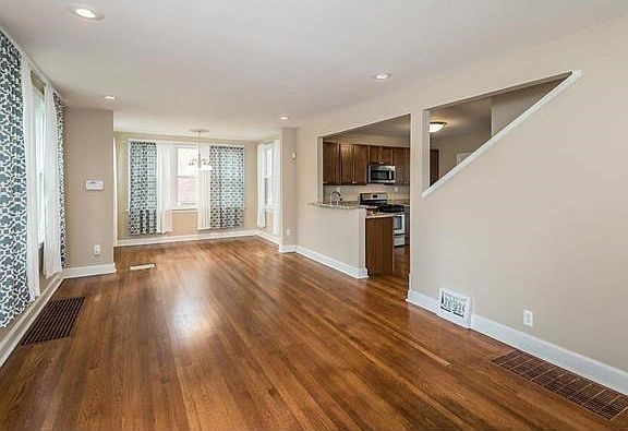 Your glimpse from the entry of the Living Room and the Windowed Dining Room beyond.  Not see in the photo is the fireplace and entertainment central location.  A glimpse of the Kitchen id visible.