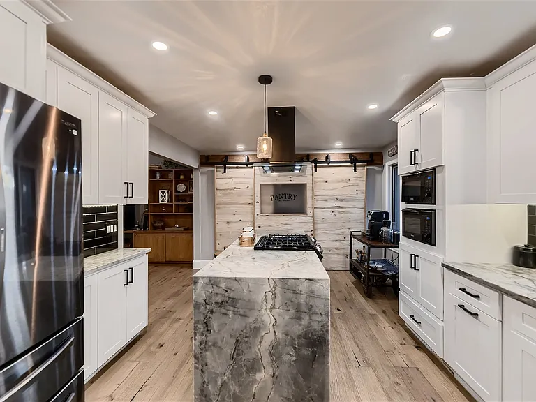 Kitchen island with pantry in the background