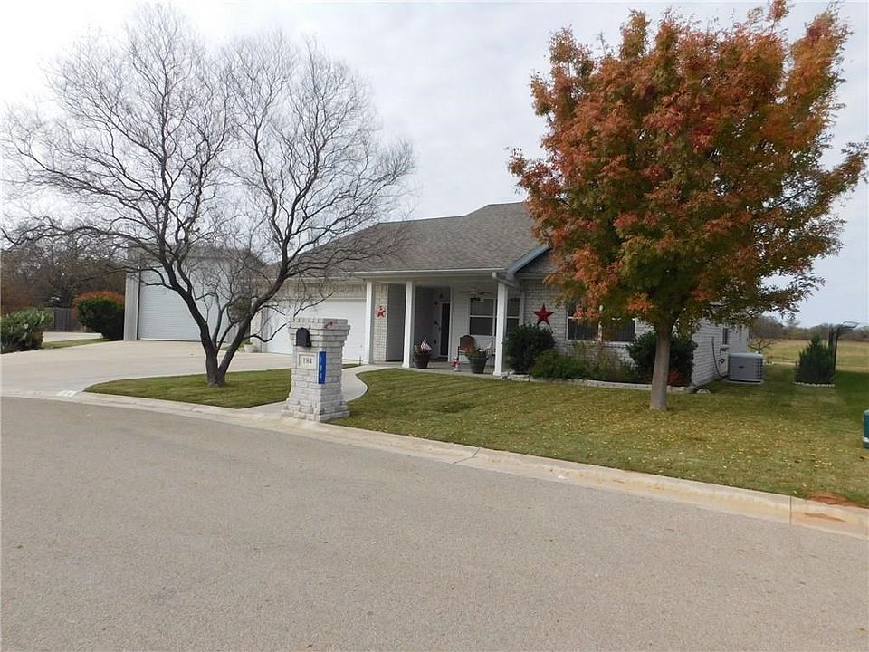 OVERSIZED LOT WITH BEAUTIFUL HOME AND SPACIOUS RV SHED AND SHOP.