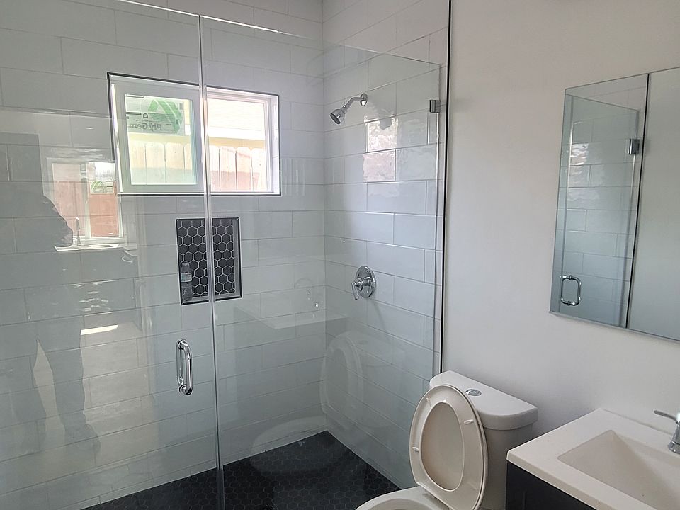 tiled shower with glass door