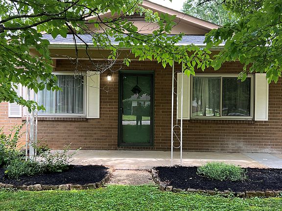 Welcoming green door, bright cheerful shutters.