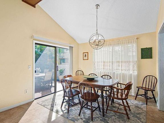 Large dining space for family gatherings with a patio to one side and the kitchen on the other. Great for entertaining.