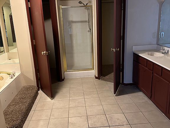master bathroom with shower and tub with jets and two large closets.