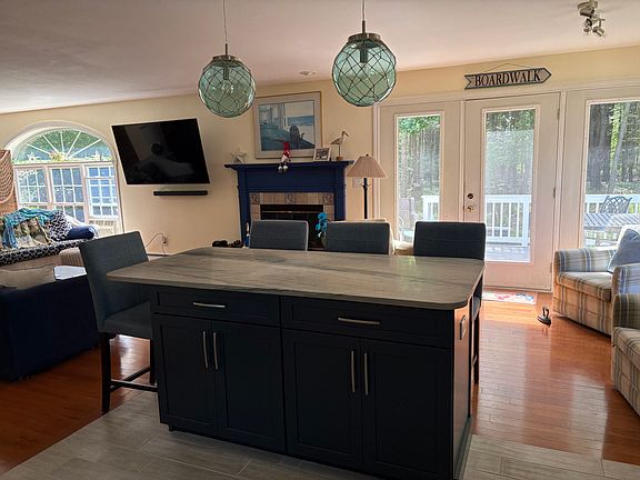 Island in kitchen open to sitting area and living room