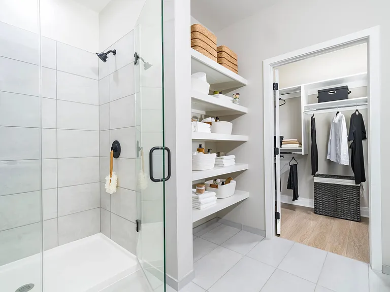 Frameless glass showers & floor-to-ceiling tile create a spa-like retreat at home!