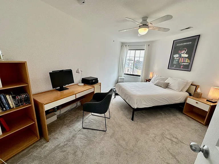 Spacious bedroom featuring premium Tempur-Pedic mattress and a dedicated workspace.