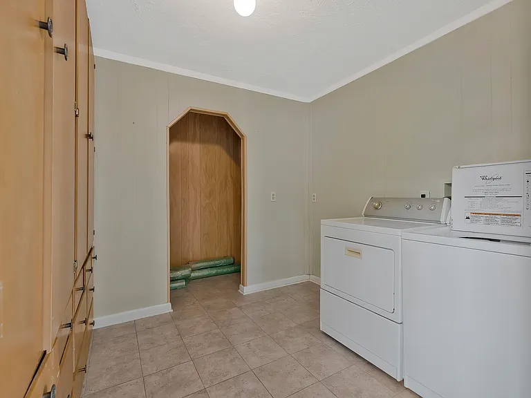 Photo 14. Laundry room with washer, dryer, and built-in floor to ceiling cabinets