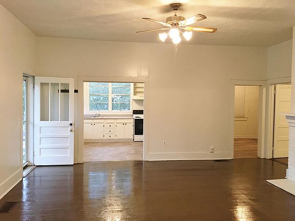 living room looking toward the kitchen, doors to bedroom and office