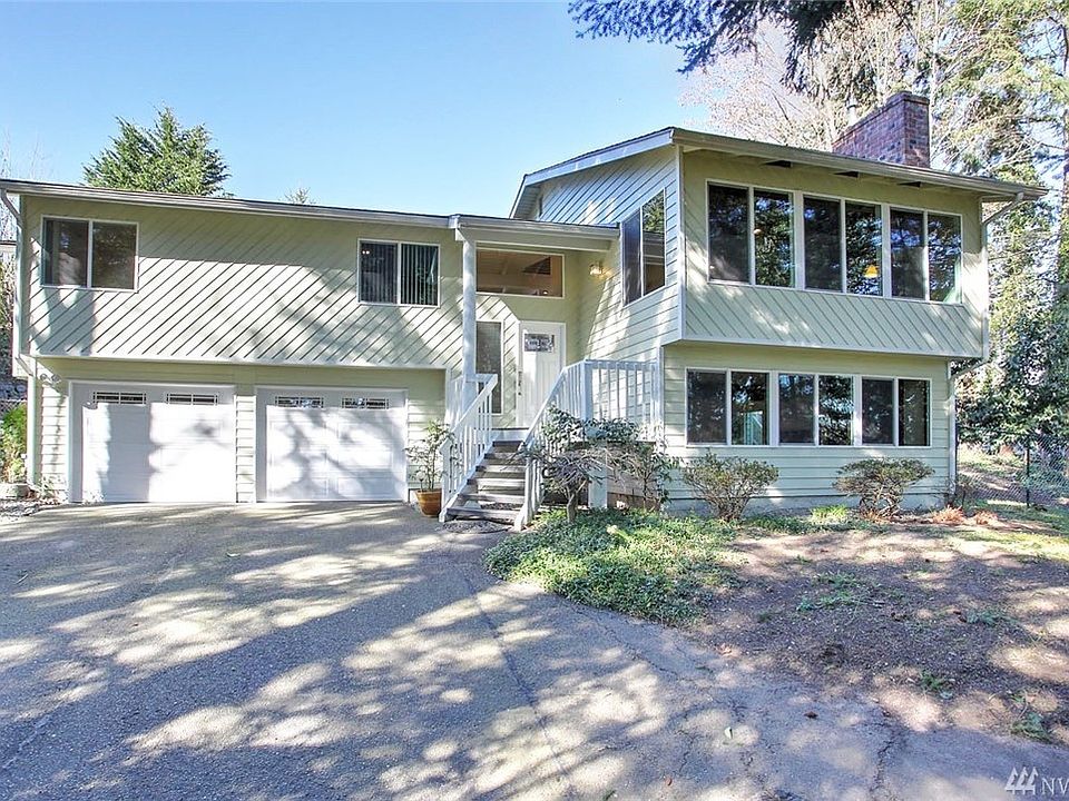 Welcome home to this enchanting 4 bedroom, 3 bath home. It will delight at every turn, and you'll feel a million miles away as it has been beautifully designed and remodeled to highlight the lush Northwest setting. Situated on 1+ acres, this gated property is a secluded retreat. Surrounded by trees, you'll be surprised by the abundant windows and skylights making it light and bright inside. Made for entertaining you can gather with friends in the open-concept floorplan uniting the chef's dream kitchen to the cozy family room & spacious dining area, or enjoy the intimate formal living room with walls of windows. A large slider leads to the entertainment sized deck running the length of the home where you can take full advantage of the gorgeous back yard and waterfall. The master suite also features a large slider to the deck and overlooks the incredible waterfall-and this open door brings the delightful sound of falling water into the bedroom.