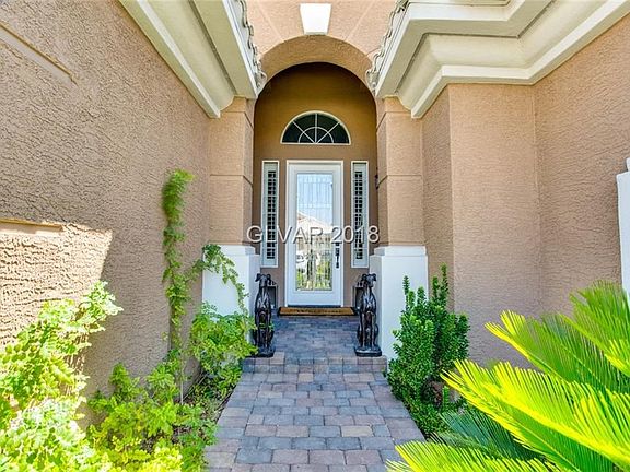 Inviting Front Entry with beautiful beveled glass door and brick paver walkway.
