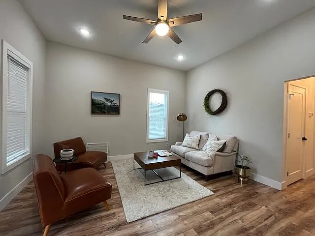 Comfortable living space with high ceilings and large window fsor ample natural lighting.