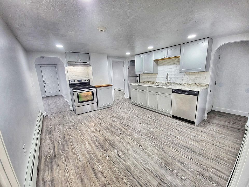 Large eat-in kitchen with stainless steel appliances - including dishwasher.