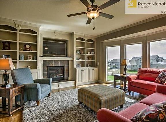 Great room with fireplace, wall of windows and built-ins