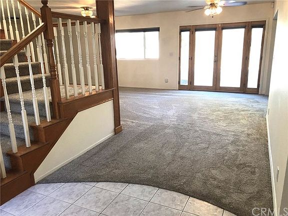 Entry looking towards back of house and living room with new carpet