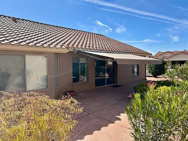 Backyard with new retractable awing. Plenty of outdoor patio space. - 16242 W Vale Dr