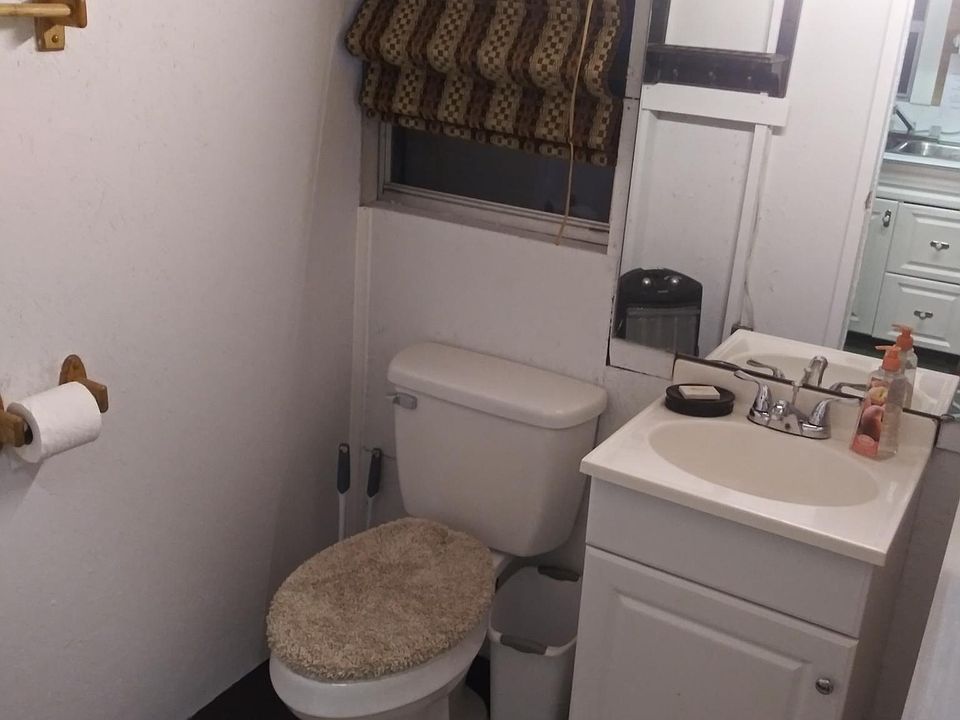 BATH ROOM HAS NEW CHAIR HEIGHT ELONGATED TOILET AND NEW SEAT COVER AND FLOOR CARPETS.