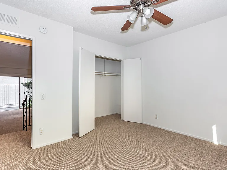 Bedroom #2 from another view facing large closet. Step down into living room.