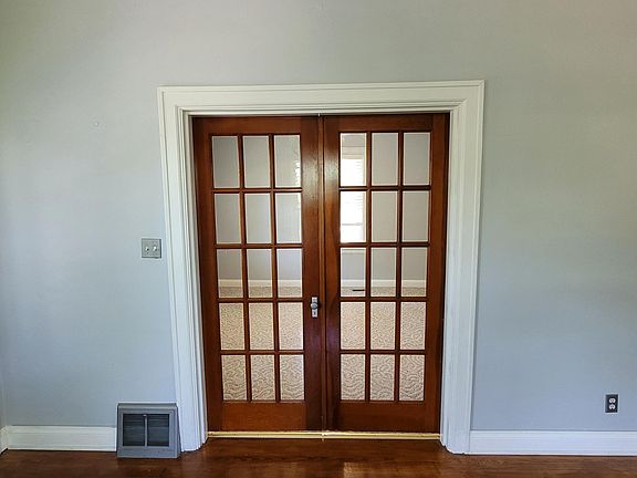 Photo of living room facing into 2nd bedroom or office room. Note the original hardwood floors!