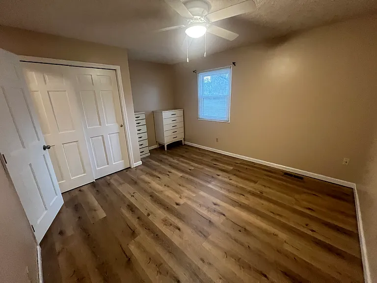 This is bedroom number four with new LVP flooring and it has two dressers in this room allowing you to customize the rest of the room yourself. New lighting, freshly painted!