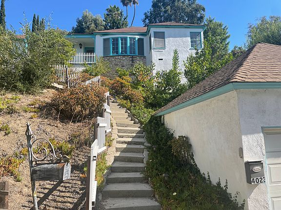 Includes garage at street level and space next to the house for 2 cars