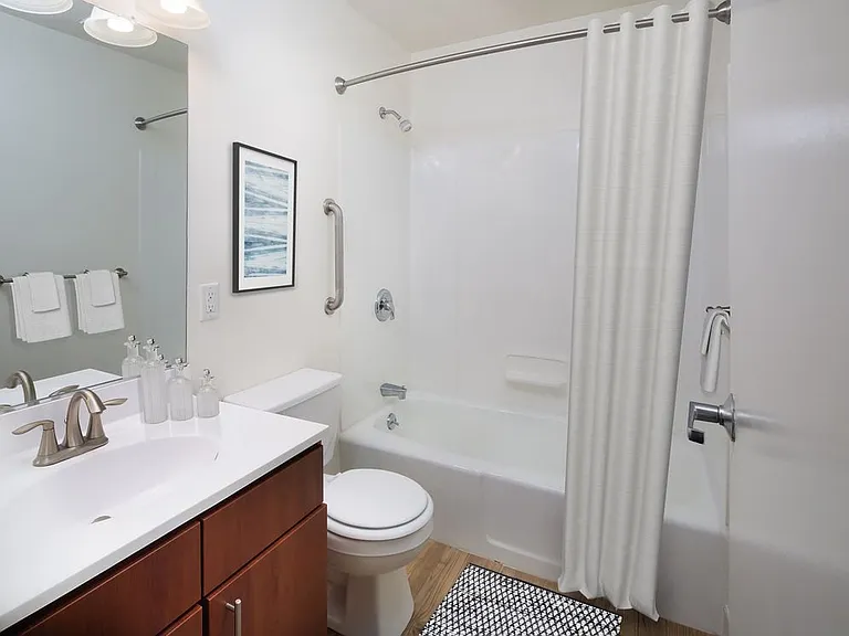 Classic Package II bath with white laminate countertops, cherry cabinetry, and hard surface flooring