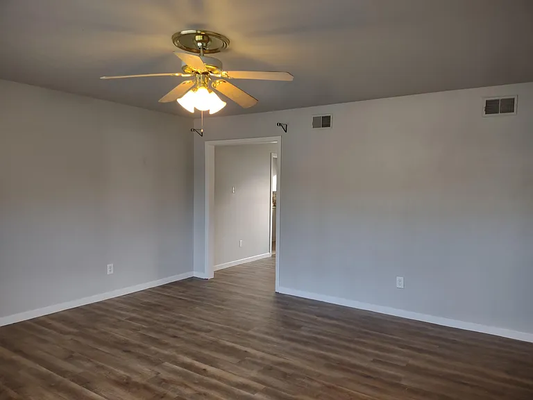 View of living room from front door. Opening goes to dining room.