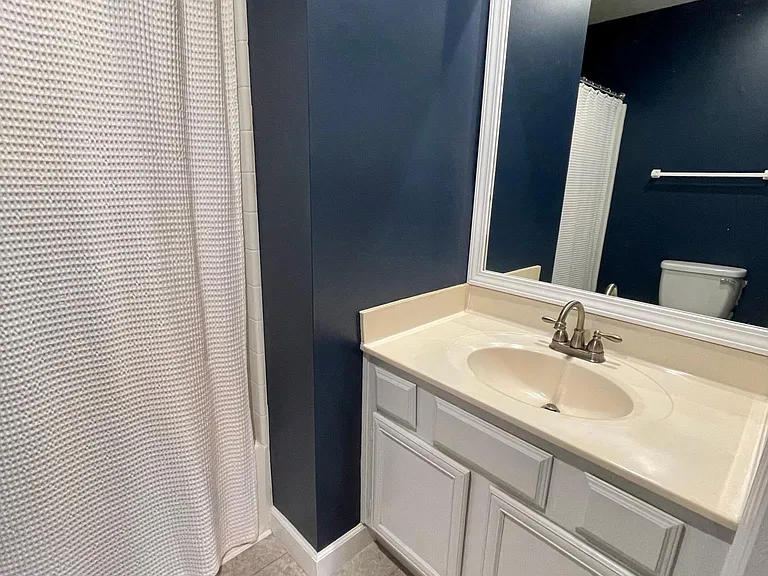 Ensuite master bath features a brand new toilet, a bathtub/shower combination with exceptional water pressure, and under-cabinet storage.