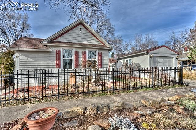 House, studio/cottage, detached garage, metal and wood fencing, fully landscaped front and back yards and curb yard